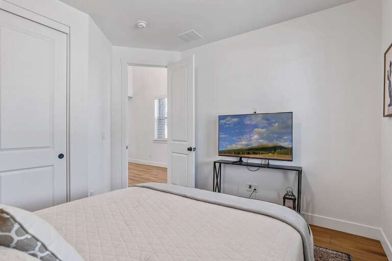 1st Floor - Bedroom 1: Queen bed, smart TV, and full bathroom with shower/tub combo 1st Floor - Bedroom 1: Queen bed, smart TV, and full bathroom with shower/tub combo