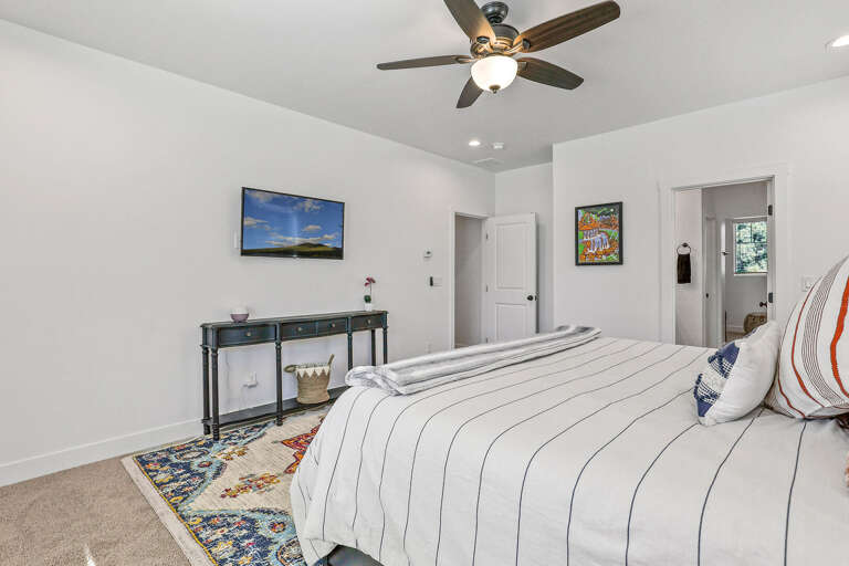 2nd Floor - Master Bedroom: King bed, smart TV, en-suite bath with dual vanities, glass shower, and walk-in closet 2nd Floor - Master Bedroom: King bed, smart TV, en-suite bath with dual vanities, glass shower, and walk-in closet