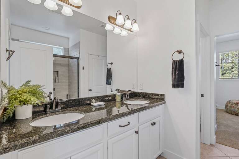 2nd Floor - Master Bedroom: King bed, smart TV, en-suite bath with dual vanities, glass shower, and walk-in closet 2nd Floor - Master Bedroom: King bed, smart TV, en-suite bath with dual vanities, glass shower, and walk-in closet