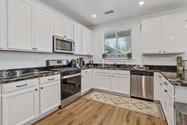 This chef's kitchen is a true showstopper, with dark granite countertops featuring cream swirls, ample cabinet and drawer space, and all the appliances you could need. This chef's kitchen is a true showstopper, with dark granite countertops featuring cream swirls, ample cabinet and drawer space, and all the appliances you could need.