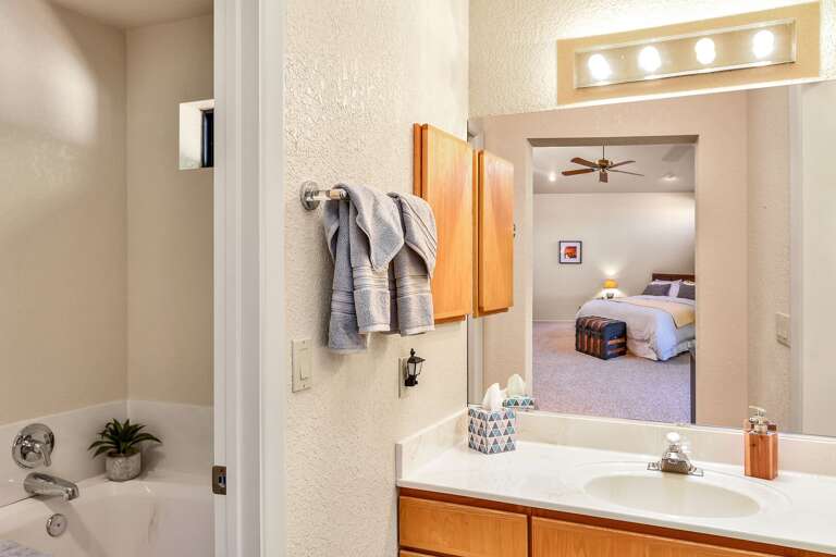 Master Suite: Features a king-size bed, Smart TV, comfy chair with ottoman, and an en suite with Master Suite: Features a king-size bed, Smart TV, comfy chair with ottoman, and an en suite with