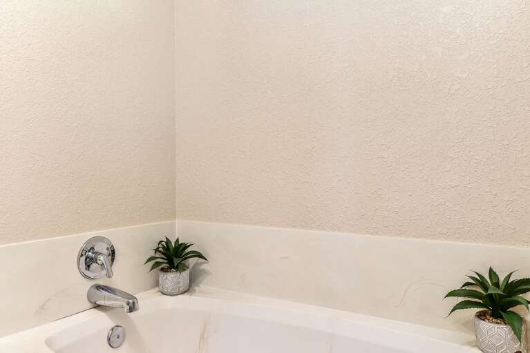 Master Suite: Features a king-size bed, Smart TV, comfy chair with ottoman, and an en suite with Master Suite: Features a king-size bed, Smart TV, comfy chair with ottoman, and an en suite with