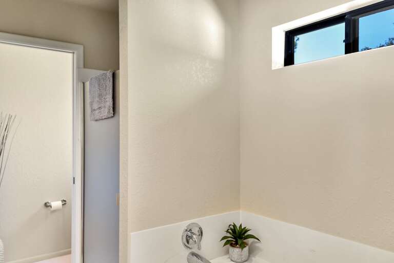 Master Suite: Features a king-size bed, Smart TV, comfy chair with ottoman, and an en suite with Master Suite: Features a king-size bed, Smart TV, comfy chair with ottoman, and an en suite with