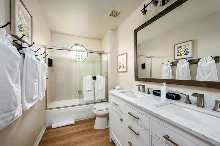 Hall bathroom with double sinks and combo shower tub. Hall bathroom with double sinks and combo shower tub.