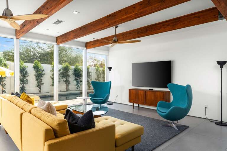 Retro sitting chairs, large TV and comfy seating in the living room. Retro sitting chairs, large TV and comfy seating in the living room.