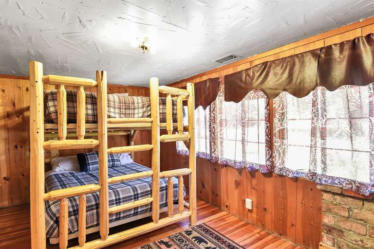 Bedroom 3: Custom Queen-over-Queen bunk bed with hand-crafted wooden accents  and flat-screen TV with DVR