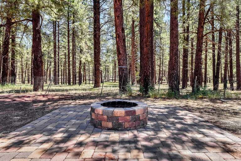 Gather around the firepit and enjoy cozy evenings under the stars at this charming cabin retreat.