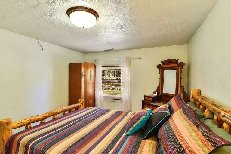 Sleep soundly in this charming home's queen bed, where comfort and tranquility await.