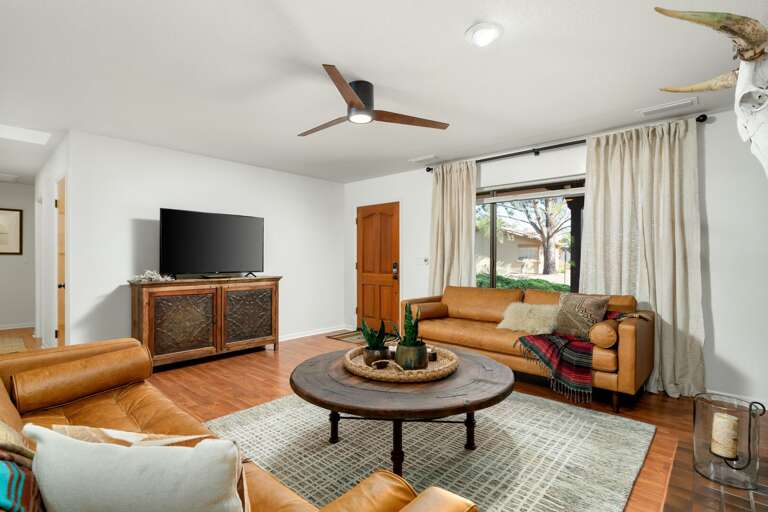 Natural light pours through large windows, highlighting rich wooden accents and offering stunning red rock views. Natural light pours through large windows, highlighting rich wooden accents and offering stunning red rock views.