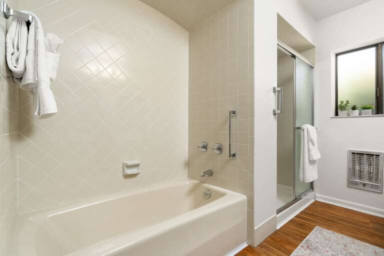 Shared Full Bathroom: Boasts a contemporary walk-in shower and a relaxing soaking tub, sophisticated fixtures, and plenty of space to meet your needs. Shared Full Bathroom: Boasts a contemporary walk-in shower and a relaxing soaking tub, sophisticated fixtures, and plenty of space to meet your needs.