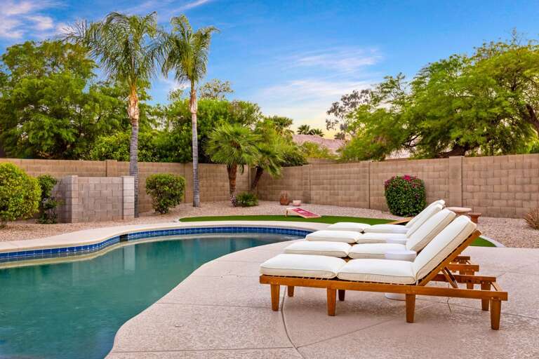 Relax in Sun Beds Near The Pool w/ Nearby Palms Relax in Sun Beds Near The Pool w/ Nearby Palms