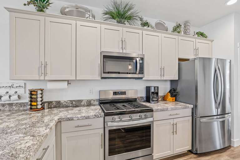 Fully equipped for your convenience, this modern kitchen features a refrigerator, stove, oven, microwave, and coffeemaker – everything you need to feel at home. Fully equipped for your convenience, this modern kitchen features a refrigerator, stove, oven, microwave, and coffeemaker – everything you need to feel at home.