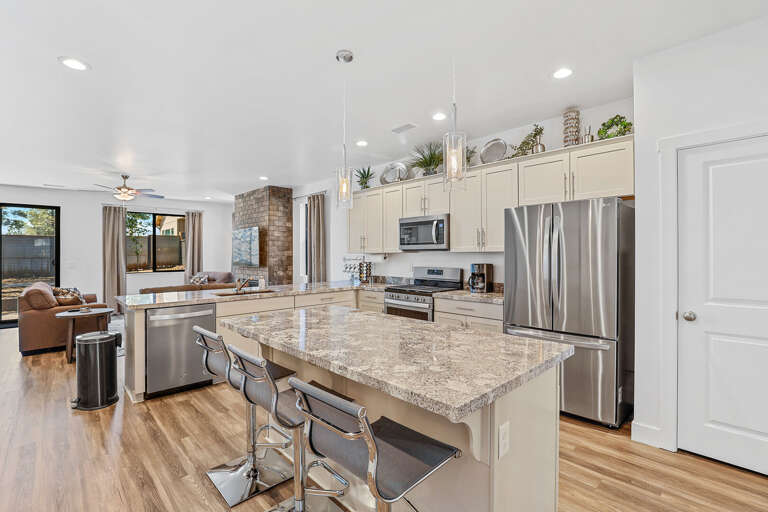 Gather around the spacious kitchen counter in this modern kitchen, where style meets functionality for the ultimate cooking experience. Gather around the spacious kitchen counter in this modern kitchen, where style meets functionality for the ultimate cooking experience.