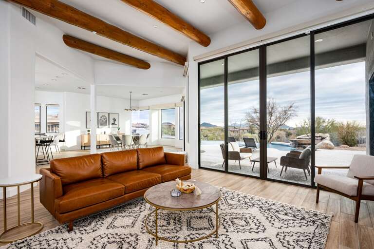 This home is grand with its exposed wood beams, openness of the floor plan, and many windows to the great outdoors. This home is grand with its exposed wood beams, openness of the floor plan, and many windows to the great outdoors.