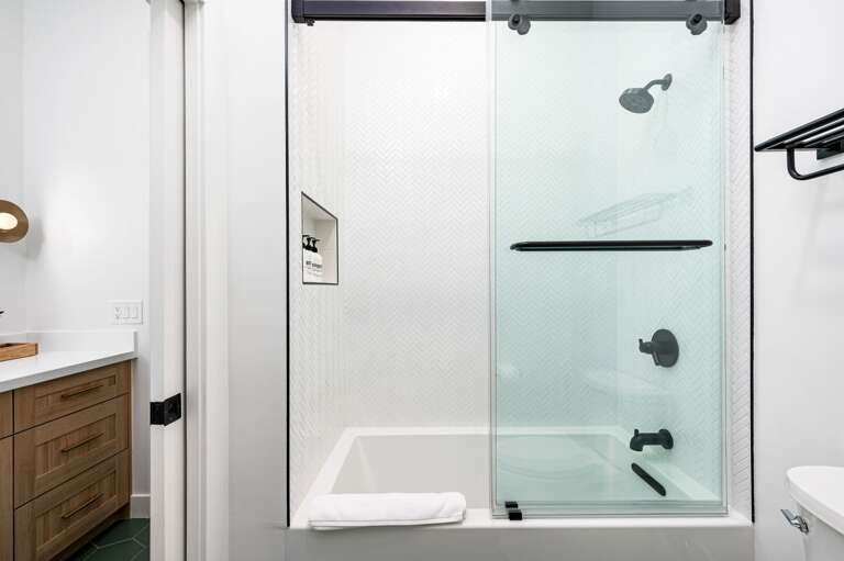 Shared combo tub and shower for the two bedrooms. Shared combo tub and shower for the two bedrooms.