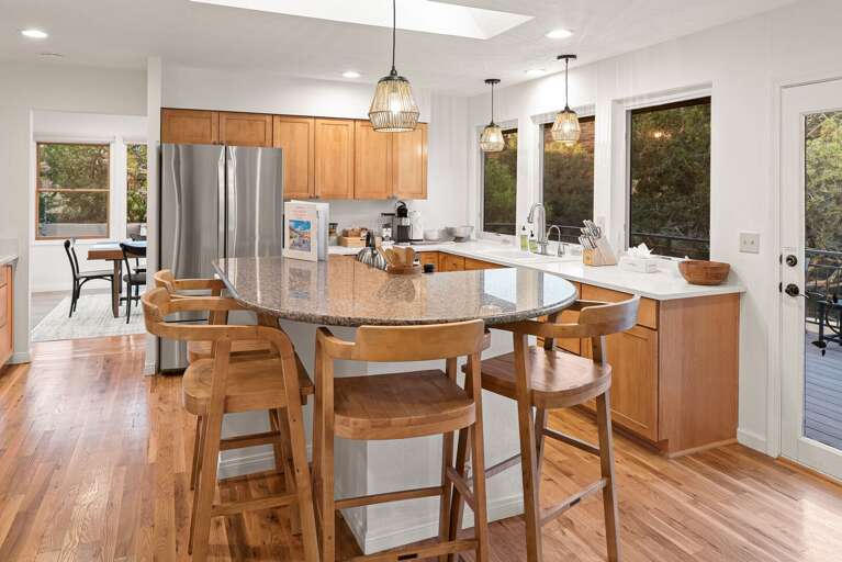 Fully Equipped Kitchen w/ Center Island & Dining Area in Background Fully Equipped Kitchen w/ Center Island & Dining Area in Background