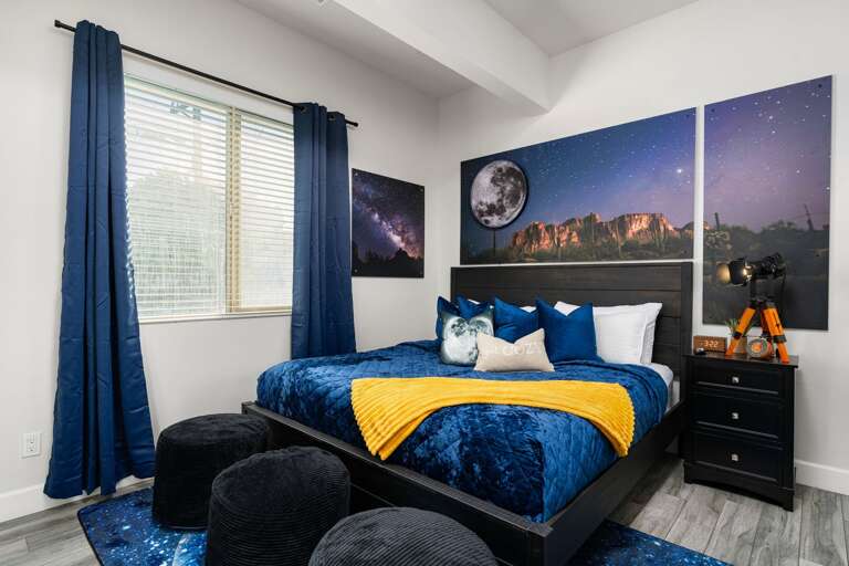 Stylish Bedroom w/ Plush Bedding, Blackout Curtains, & a Unique Night-Sky Design for a Restful Stay