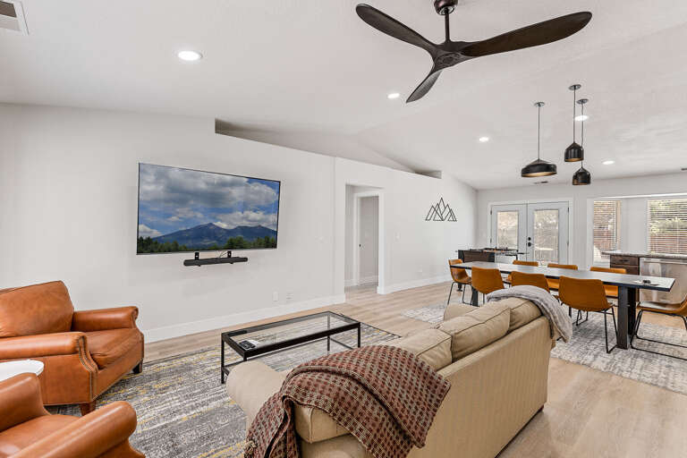 Open Concept Living: An upgraded, airy floor plan perfect for entertaining, featuring a foosball table and a dining space for 8. Open Concept Living: An upgraded, airy floor plan perfect for entertaining, featuring a foosball table and a dining space for 8.