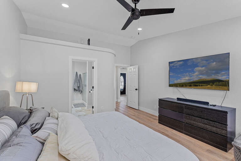 Primary Suite: King-sized bed, smart TV, XL bean bag chair, and en-suite bathroom with dual vanities and a glass shower. Primary Suite: King-sized bed, smart TV, XL bean bag chair, and en-suite bathroom with dual vanities and a glass shower.