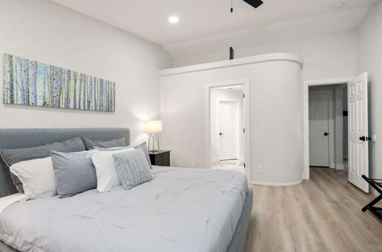 Primary Suite: King-sized bed, smart TV, XL bean bag chair, and en-suite bathroom with dual vanities and a glass shower. Primary Suite: King-sized bed, smart TV, XL bean bag chair, and en-suite bathroom with dual vanities and a glass shower.