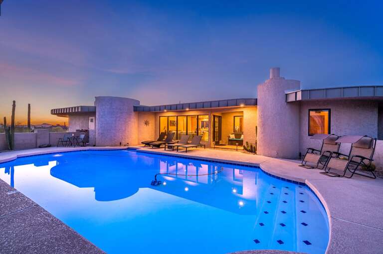 Beautiful Lit Pool w/ Poolside Seating in Background