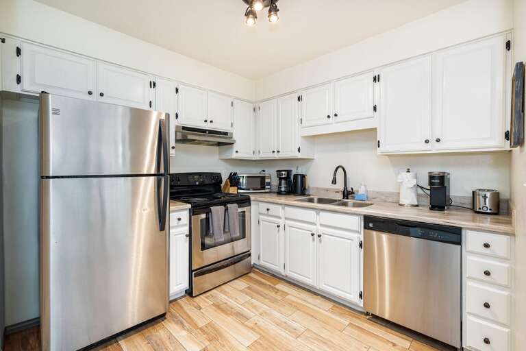 Bright, Breezy Kitchen With Stainless Steel Fixtures And White Cabinetry Bright, Breezy Kitchen With Stainless Steel Fixtures And White Cabinetry