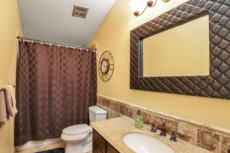 Bathroom 1 with a tiled shower conveniently located adjacent to the bedroom Bathroom 1 with a tiled shower conveniently located adjacent to the bedroom