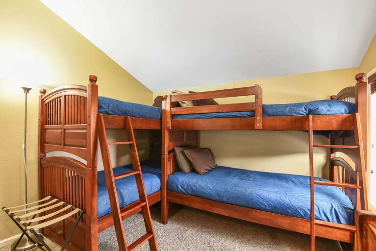 Bedroom 3 featuring 2 twin-over-twin bunk beds (sleeps 4), with a TV for streaming Bedroom 3 featuring 2 twin-over-twin bunk beds (sleeps 4), with a TV for streaming