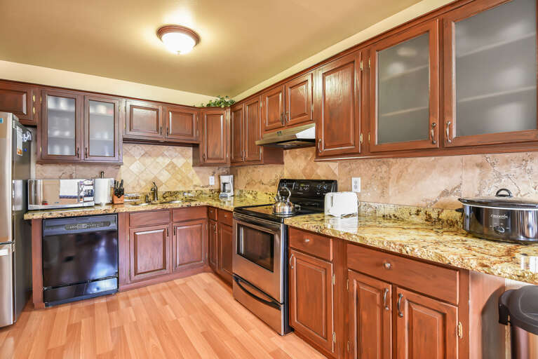 Cook up a storm in the fully equipped kitchen featuring granite countertops and modern appliances. Cook up a storm in the fully equipped kitchen featuring granite countertops and modern appliances.