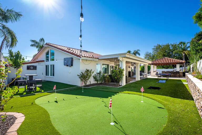Large Outdoor Putting Green With Seating in Background Large Outdoor Putting Green With Seating in Background