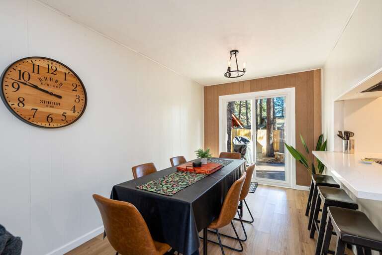 Dining Space With Large Clock, Leading To Bright Balcony Dining Space With Large Clock, Leading To Bright Balcony