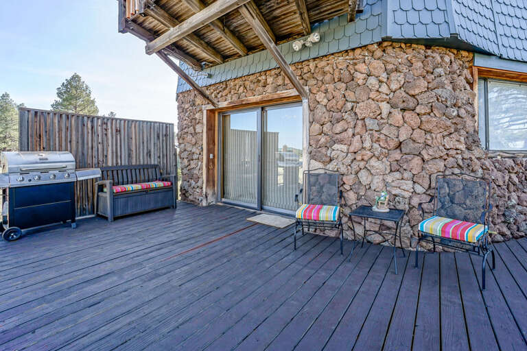 Step into the great outdoors with over an acre to explore. The deck wraps around the home, offering panoramic views and a space to gather with friends and family. Step into the great outdoors with over an acre to explore. The deck wraps around the home, offering panoramic views and a space to gather with friends and family.