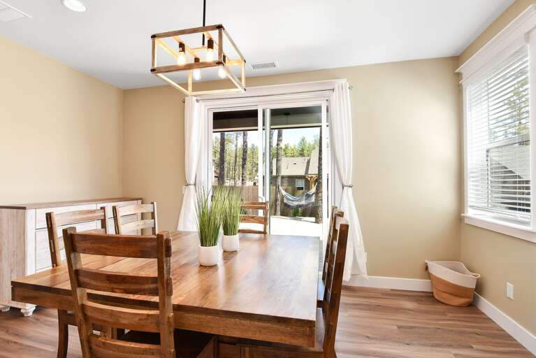 Dining table for 6 with sliding glass door leading to the backyard. Dining table for 6 with sliding glass door leading to the backyard.