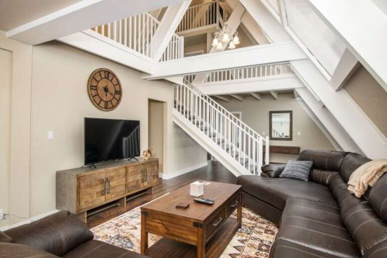 an enormous leather couch with flat-screened television. an enormous leather couch with flat-screened television.