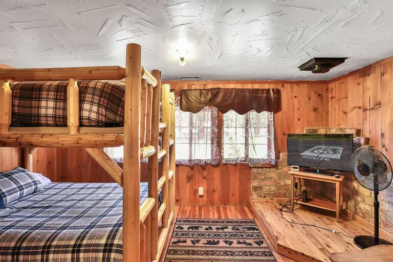 Bedroom 3: Custom Queen-over-Queen bunk bed with hand-crafted wooden accents  and flat-screen TV with DVR - perfect for slumber party