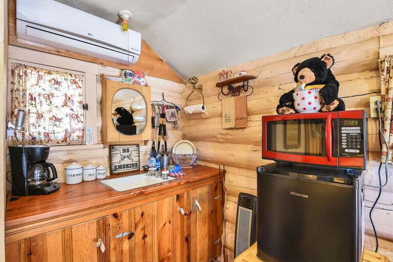 All the comforts of home in this cozy cabin, featuring a mini fridge, coffeemaker, and microwave for your convenience.