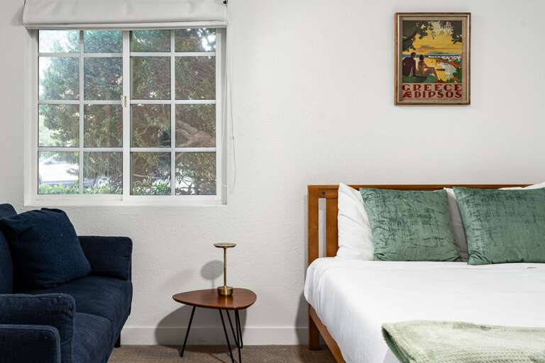 Guest room with couch and midcentury end table