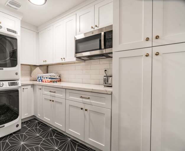 Laundry room with microwave and pantry with plenty of extra storage