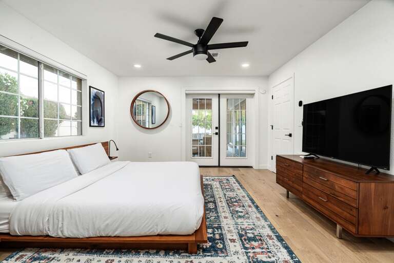 Primary bedroom with french doors to outdoor patio