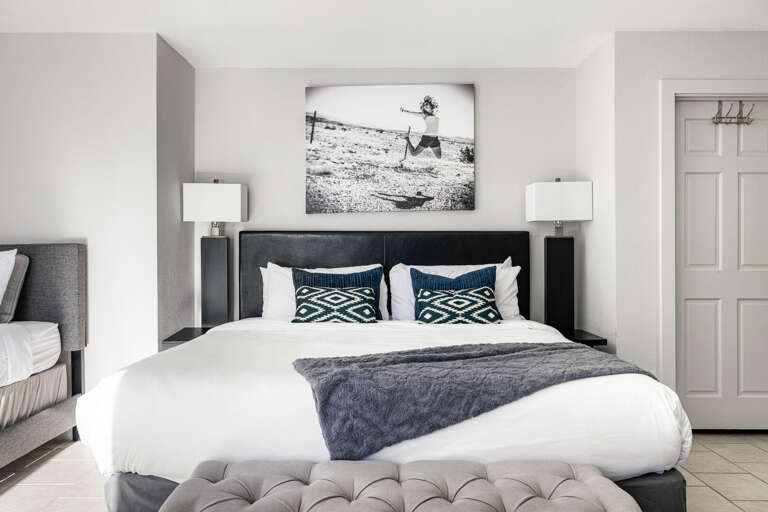 Bench at the edge of the bed for sitting.