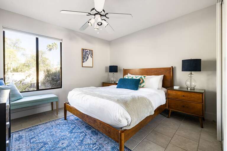 Comfy bed with a bench to sit on.