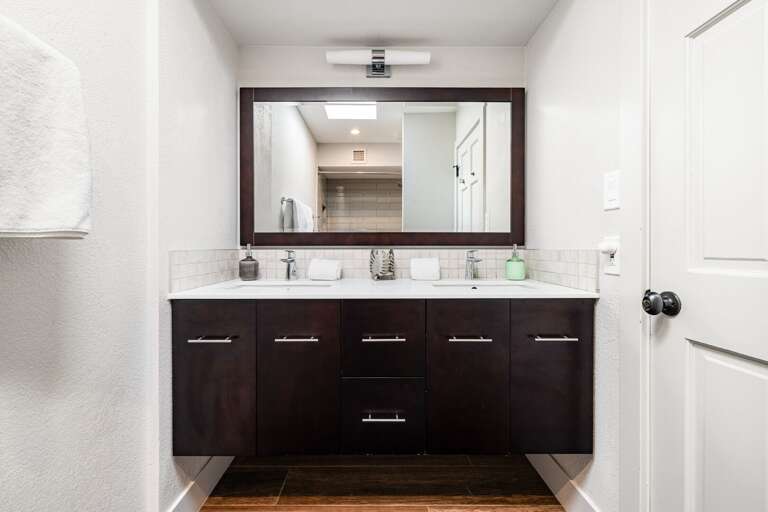 Features double vanity and large mirror.