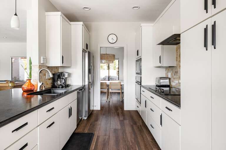 Galley kitchen with stainless steel appliances.