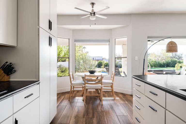 Gather around dining table surrounded by beautiful views outside.