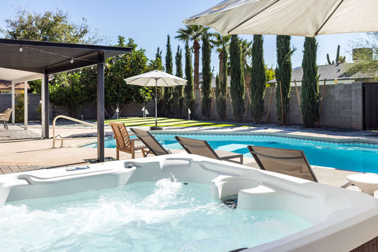 Shaded hot tub overlooking the pool