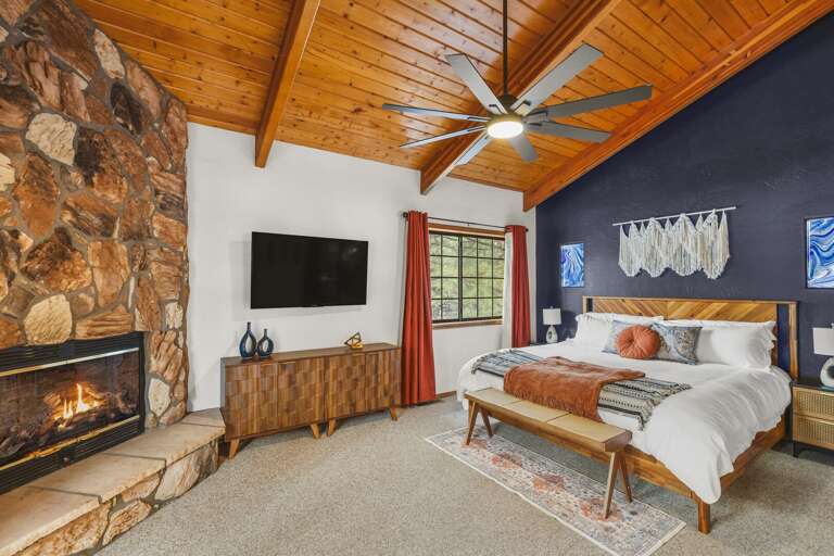 Primary bedroom with TV and Fireplace