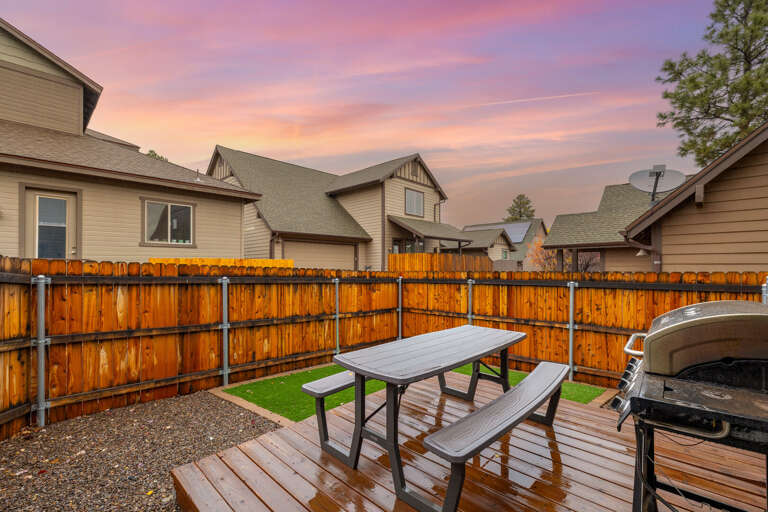 Backyard with outdoor seating and BBQ.