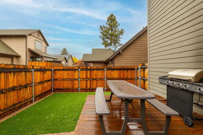 Backyard with outdoor seating and BBQ.