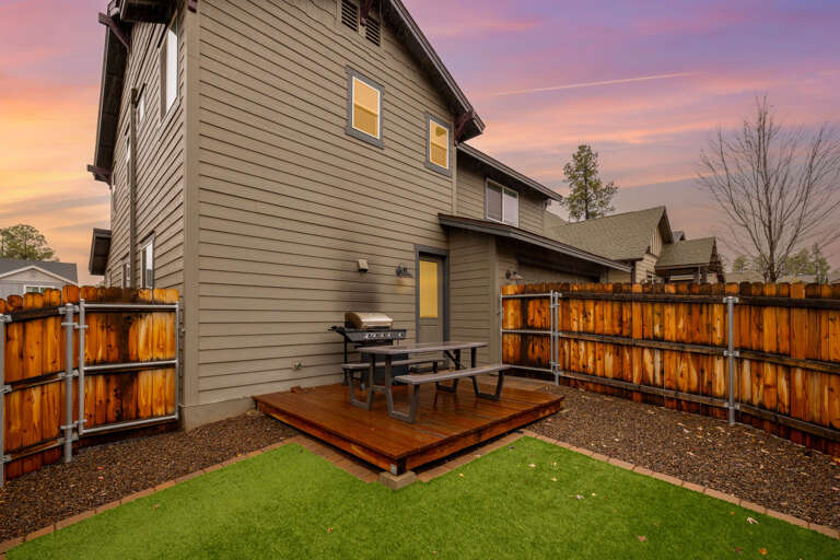 Backyard with outdoor seating and BBQ.