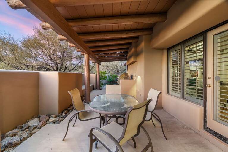 Covered patio with outdoor dining table—ideal for meals, morning coffee, or sunset evenings.